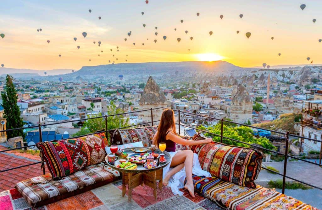 Girl with hot air balloons in Cappadocia