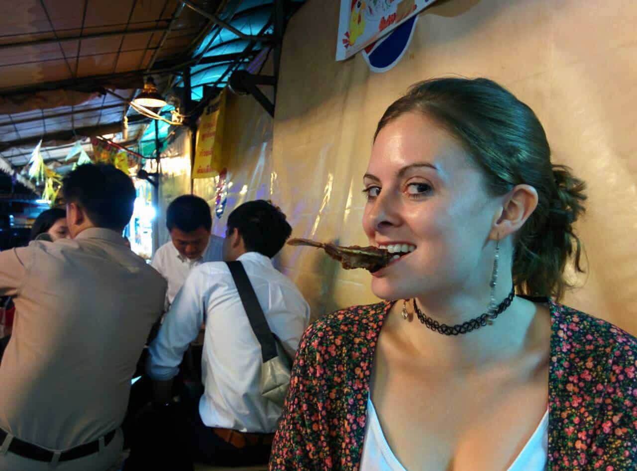 Lauren eating duck beaks in Bangkok