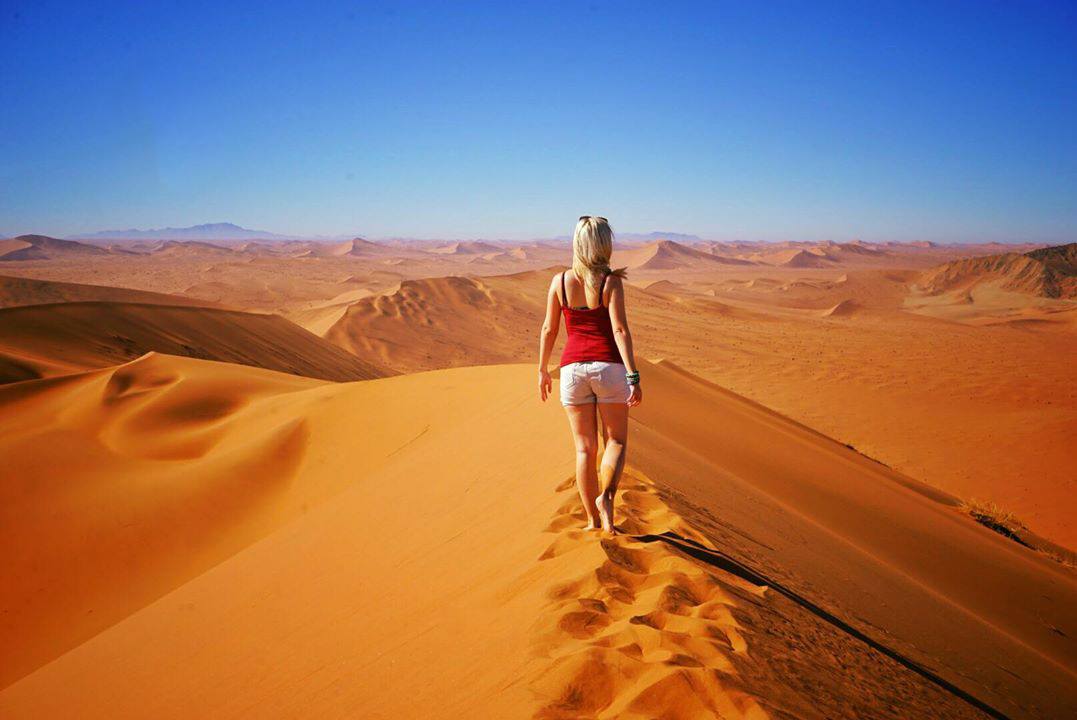 Solo woman traveler on sand dune