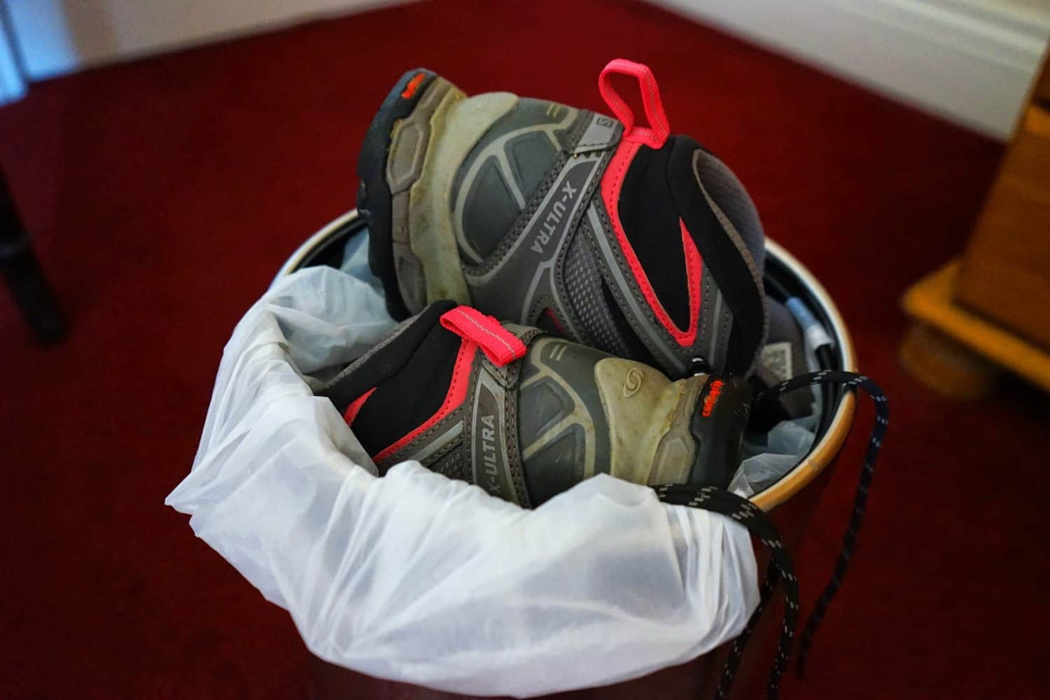Hiking shoes in the trash
