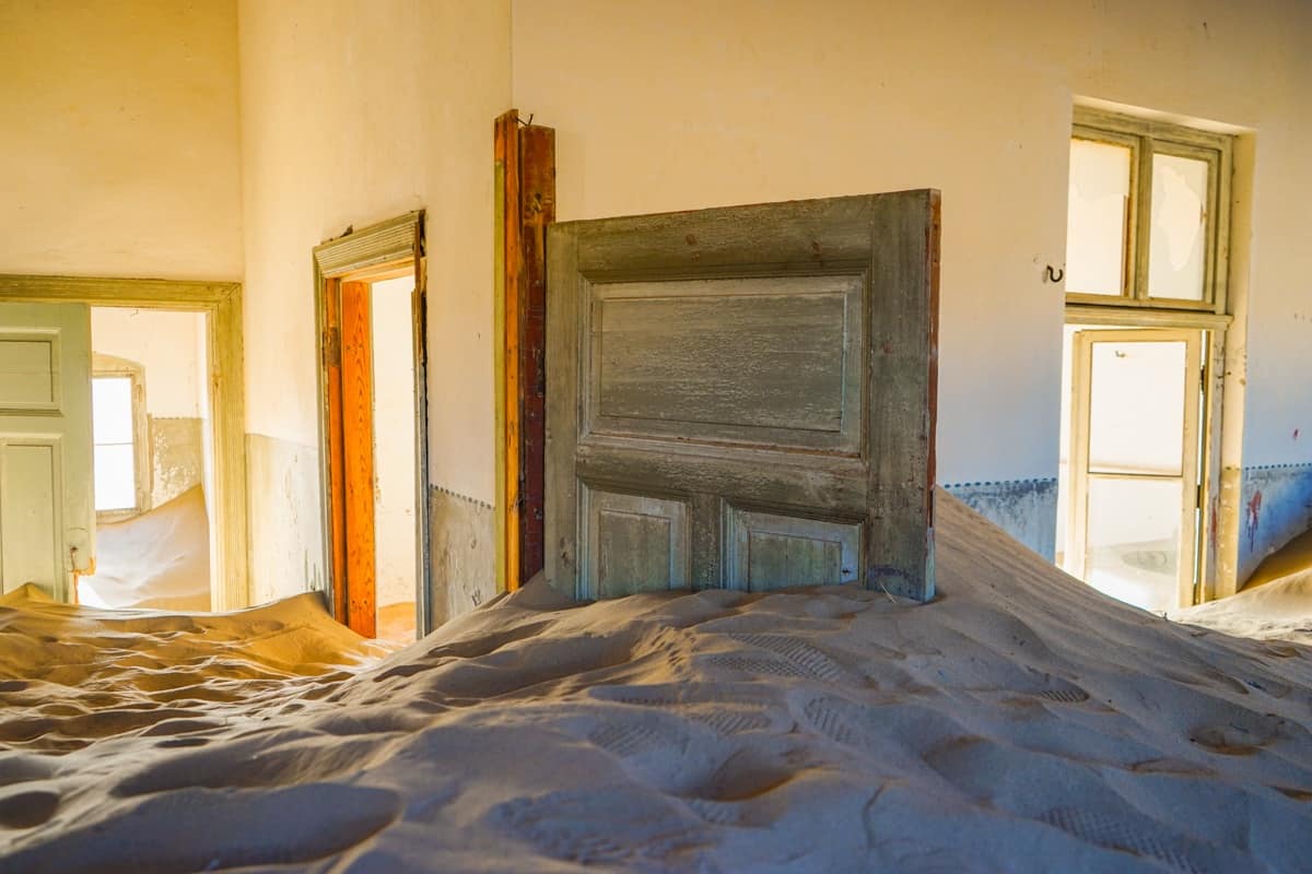 Corner of doorways and sand dunes in Kolmanskop