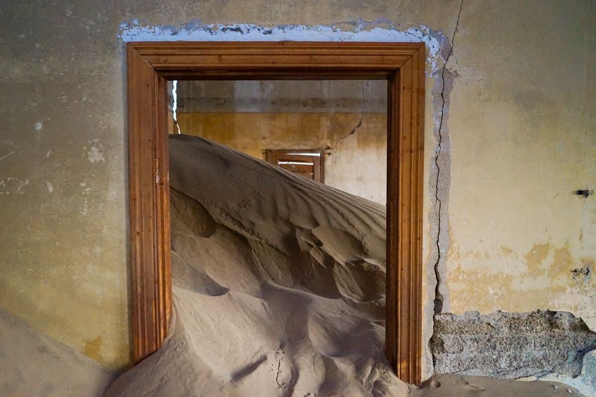 Sand dune inside doorway at Kolmanskop