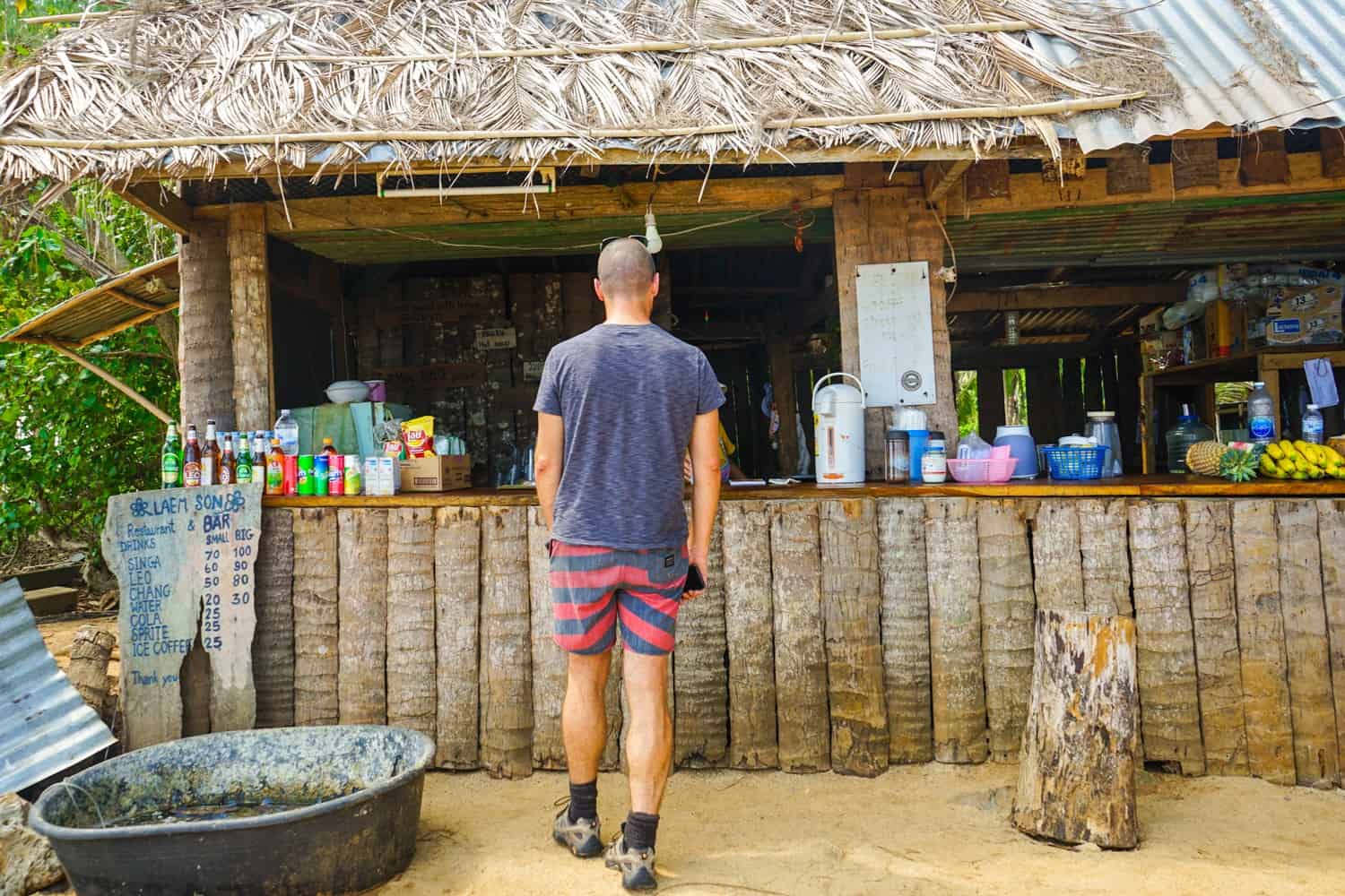 Man stood at beach bar in Thailand