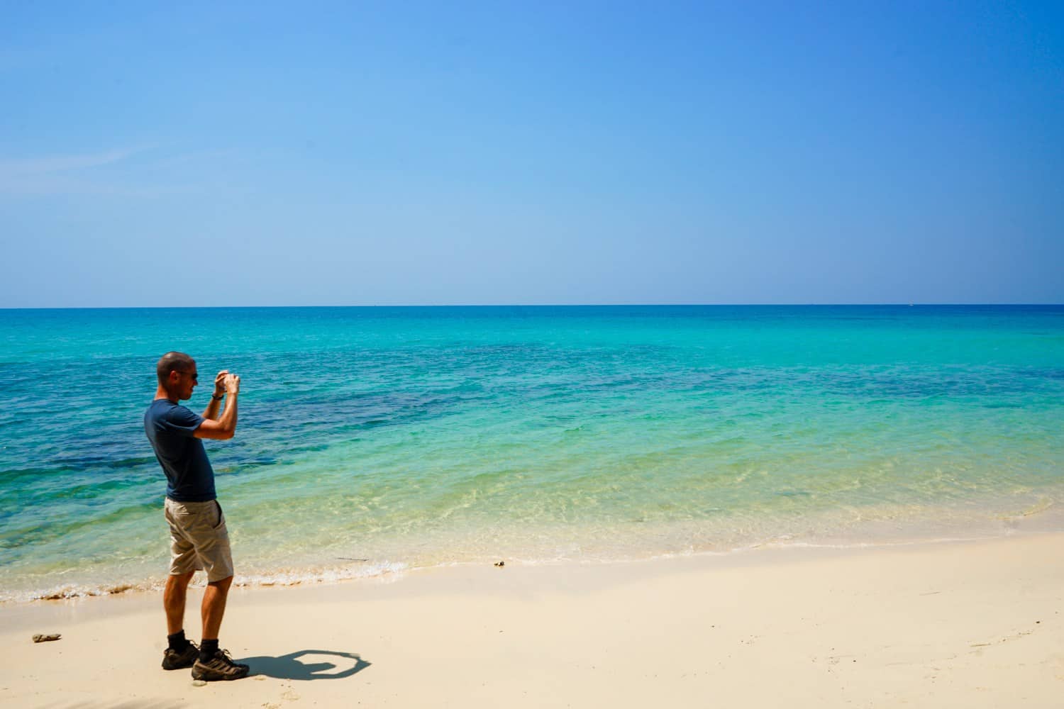 Man taking a photo of a beach in Thailand