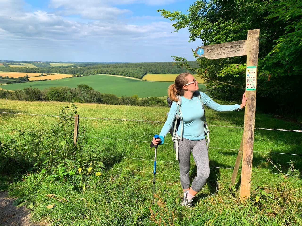 Girl looking at South Downs Way signpost