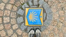 Hiking shoes with Camino sign on the ground