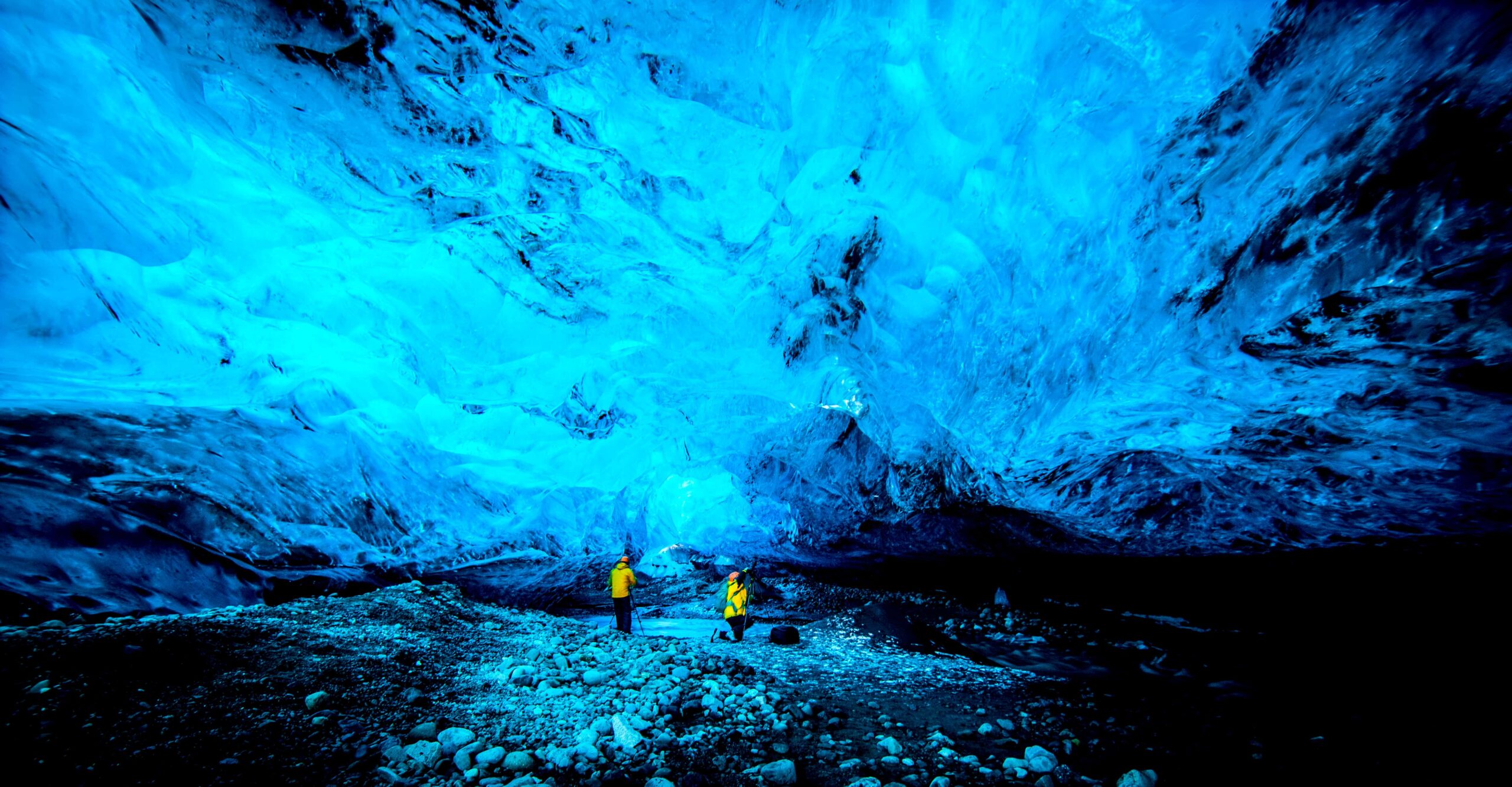 Two people in an ice cave.