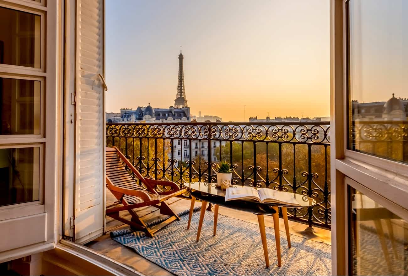 Paris at sunset from an apartment balcony, with the Eiffel Tower in the distance