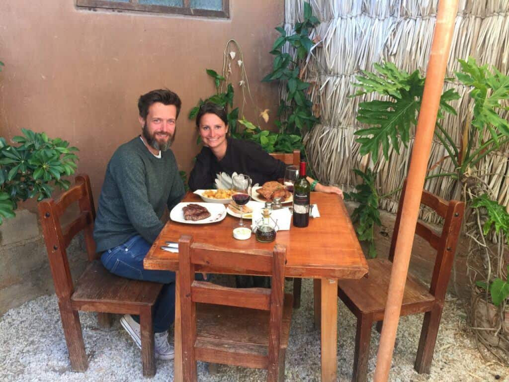 a couple eating food in a restaurant in chile