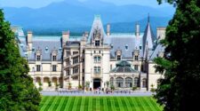 Biltmore Estate from above, with the mountains in the background and a pristine lawn in the foreground