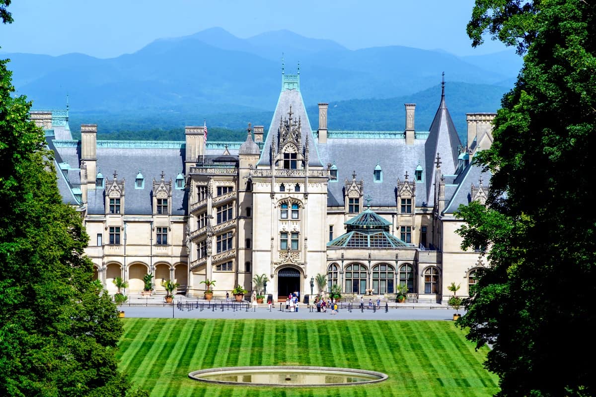 Biltmore Estate from above, with the mountains in the background and a pristine lawn in the foreground