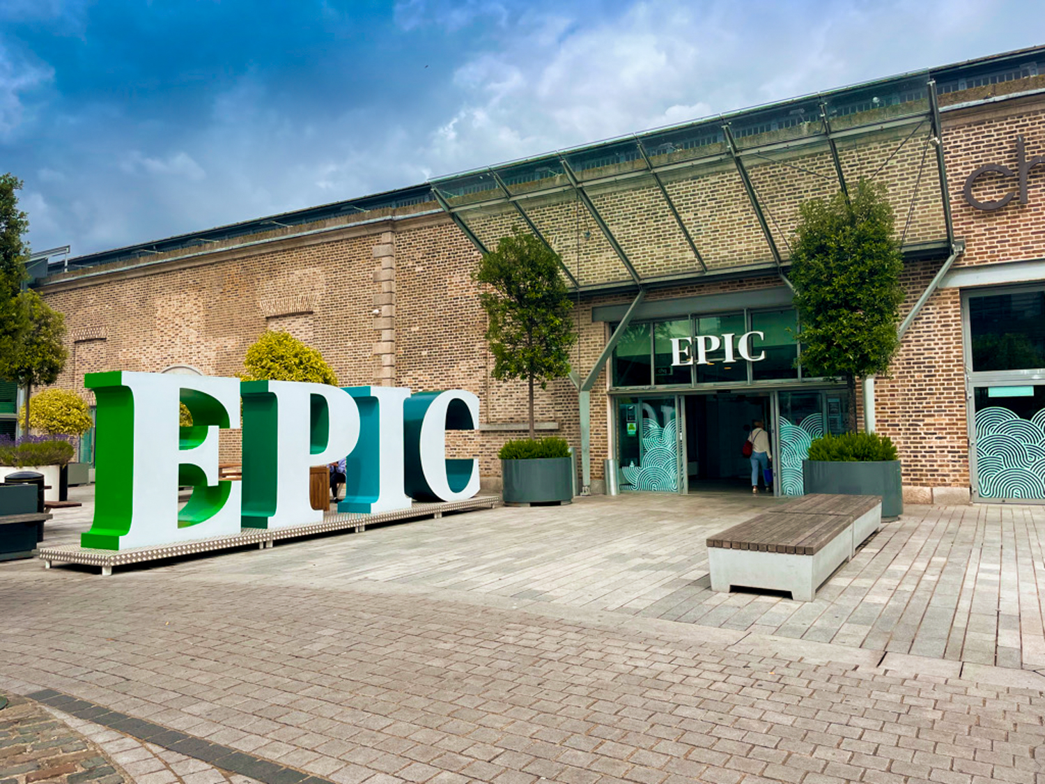 The brick facade of the EPIC museum gives way to the glass entranceway. To the side, gigantic letters reading EPIC invite visitors to take photos beside them.